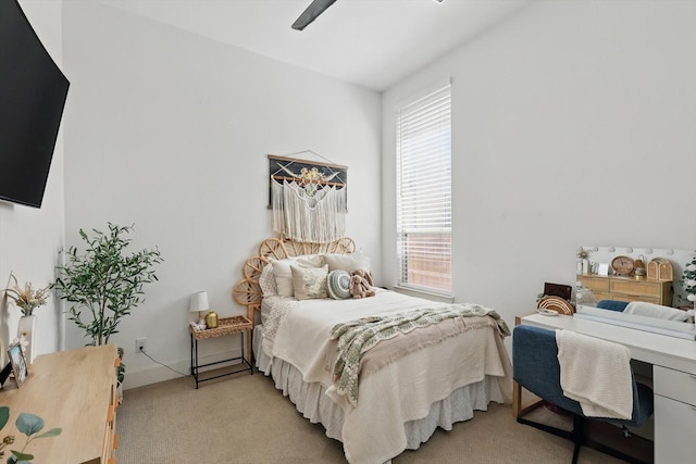 bedroom with a ceiling fan and light colored carpet