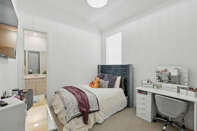 bedroom with a sink, vaulted ceiling, connected bathroom, and light carpet