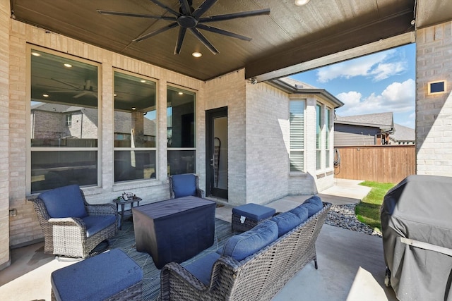 view of patio / terrace featuring an outdoor hangout area, area for grilling, a ceiling fan, and fence