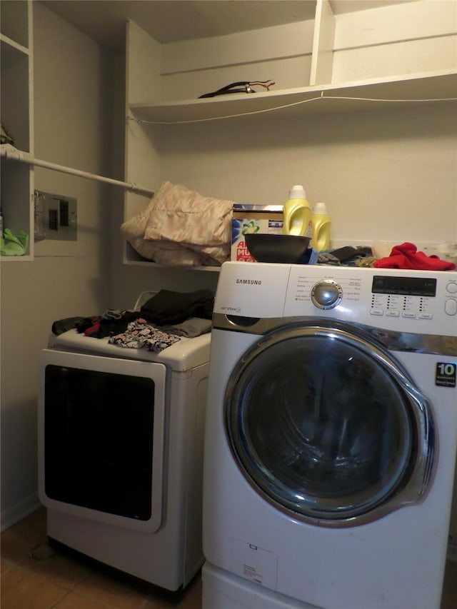 laundry room with washer and dryer, laundry area, and tile patterned floors