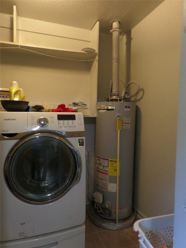 clothes washing area featuring laundry area, washer / clothes dryer, a textured ceiling, gas water heater, and tile patterned floors