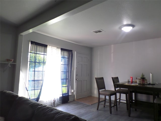 dining space featuring visible vents, plenty of natural light, and wood finished floors