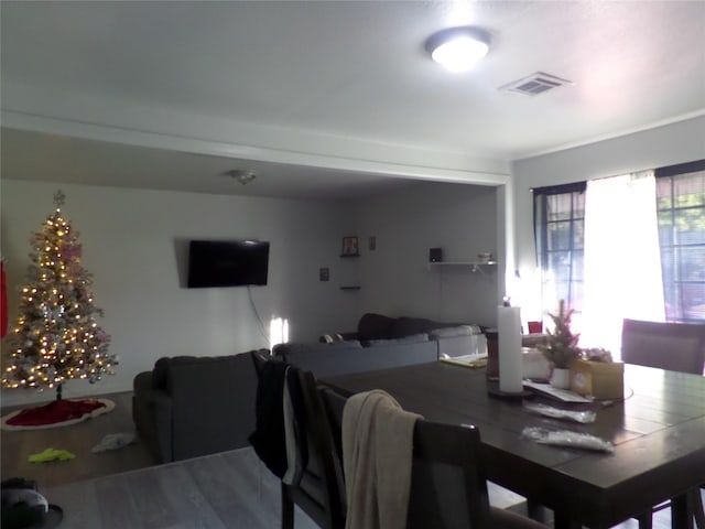 dining space featuring wood finished floors and visible vents