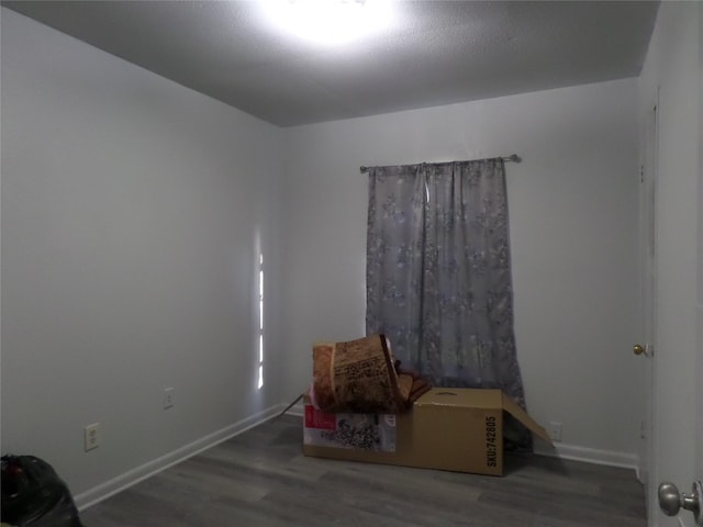 interior space featuring baseboards and wood finished floors