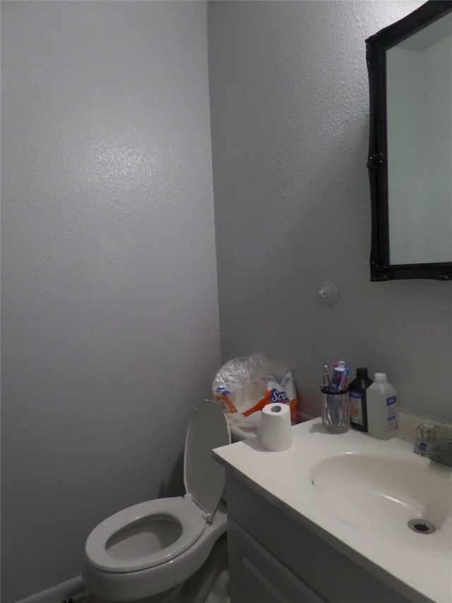 half bathroom with toilet and vanity