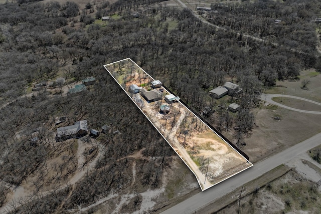 drone / aerial view featuring a view of trees