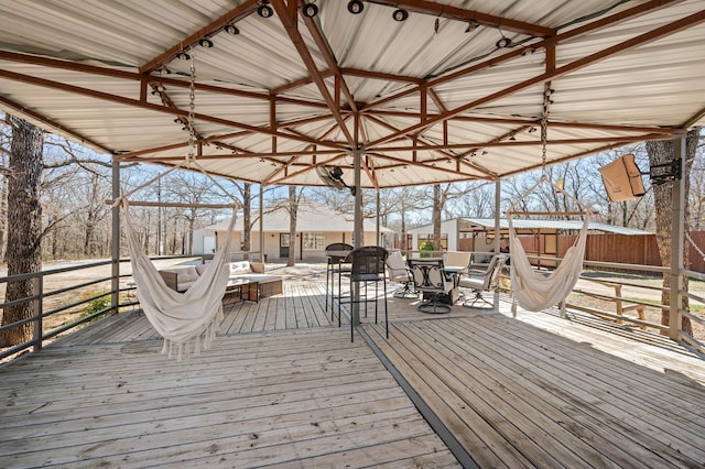wooden terrace featuring fence and outdoor dining space