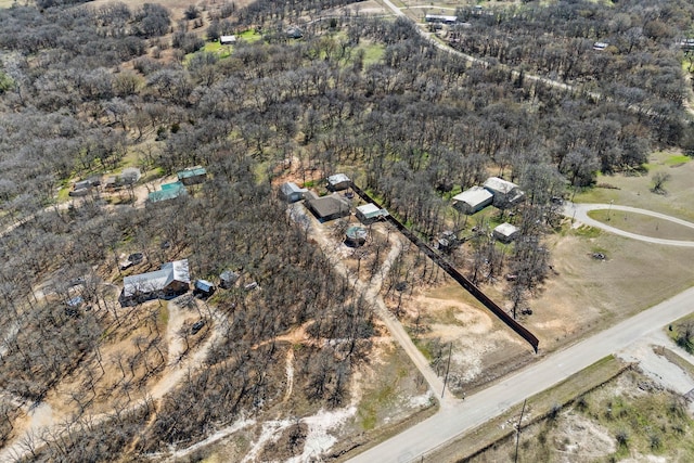 birds eye view of property featuring a view of trees