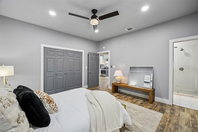 bedroom with visible vents, ensuite bath, wood finished floors, recessed lighting, and a closet