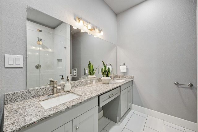 full bathroom featuring a sink, baseboards, double vanity, and a shower stall