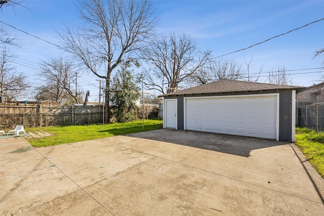 detached garage featuring fence