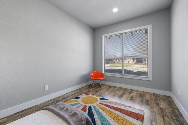 living area featuring baseboards and wood finished floors