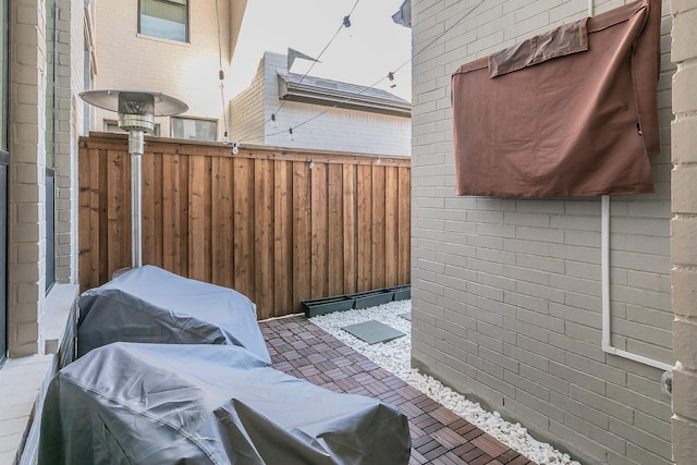 view of patio featuring area for grilling and fence