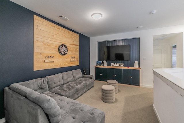 living room with visible vents, carpet flooring, and baseboards