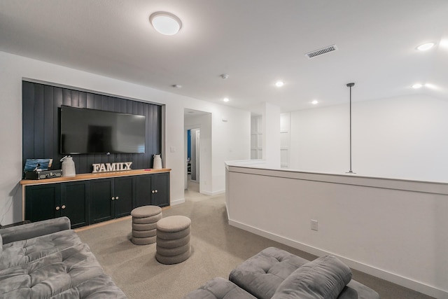 living area with visible vents, recessed lighting, baseboards, light colored carpet, and vaulted ceiling