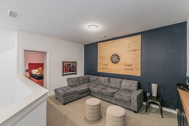 carpeted living area featuring baseboards and visible vents