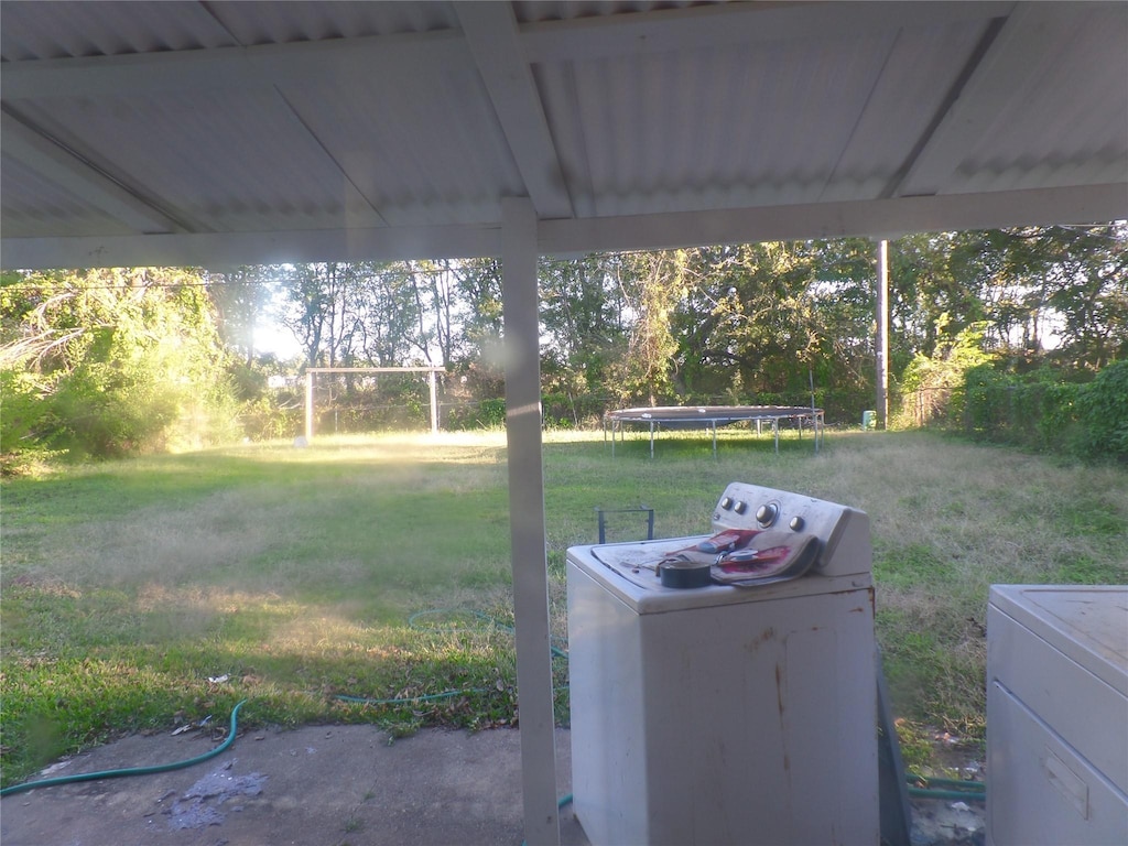 4908 Okeefe St, Bossier City, LA 71111 - view of green lawn with a trampoline and washer and clothes dryer