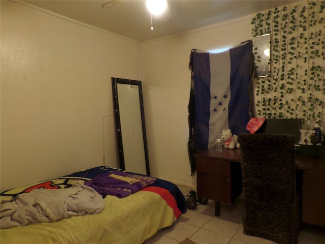 bedroom featuring light tile patterned floors and ornamental molding