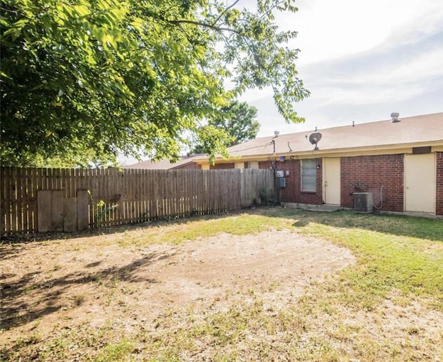 view of yard with cooling unit and fence