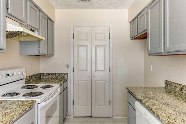 kitchen featuring white appliances, marble finish floor, gray cabinets, and under cabinet range hood