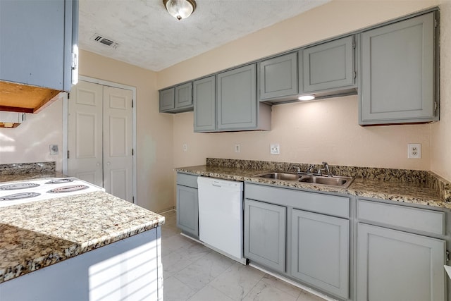 kitchen with visible vents, marble finish floor, a sink, a textured ceiling, and dishwasher