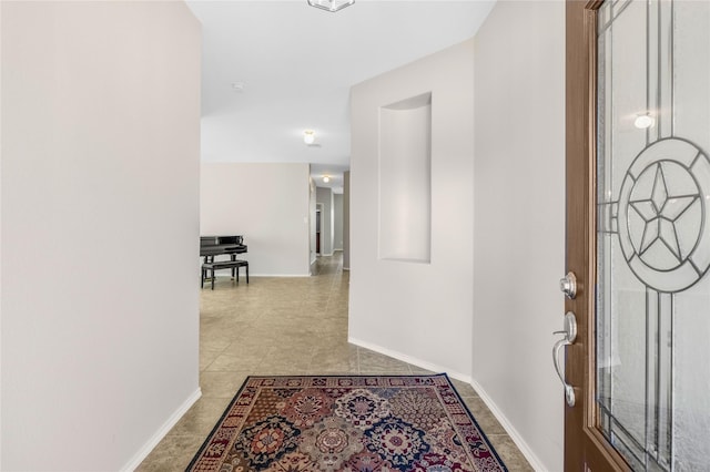 entrance foyer featuring light tile patterned flooring and baseboards