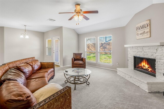 living area with baseboards, carpet floors, a fireplace, vaulted ceiling, and ceiling fan with notable chandelier