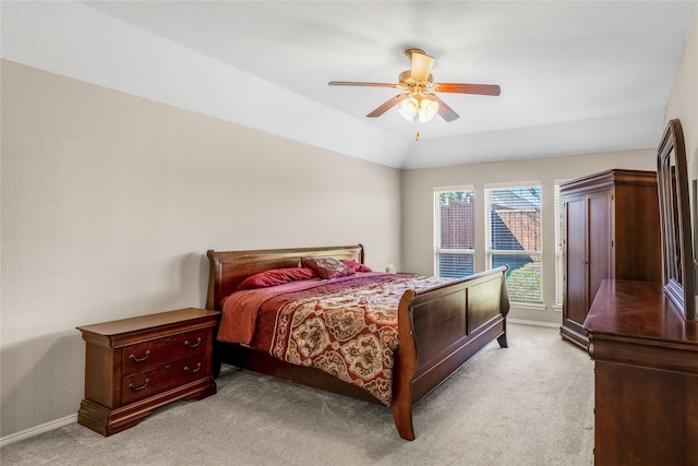 bedroom with baseboards, lofted ceiling, light carpet, and ceiling fan