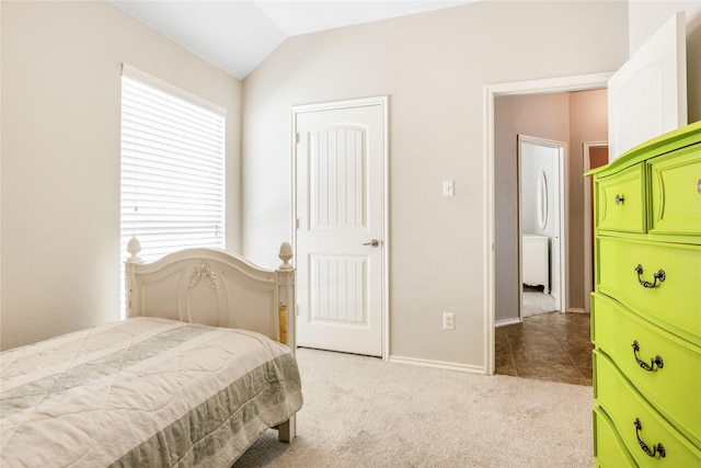 carpeted bedroom featuring vaulted ceiling