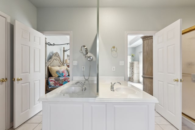 full bath with a sink, double vanity, and tile patterned flooring