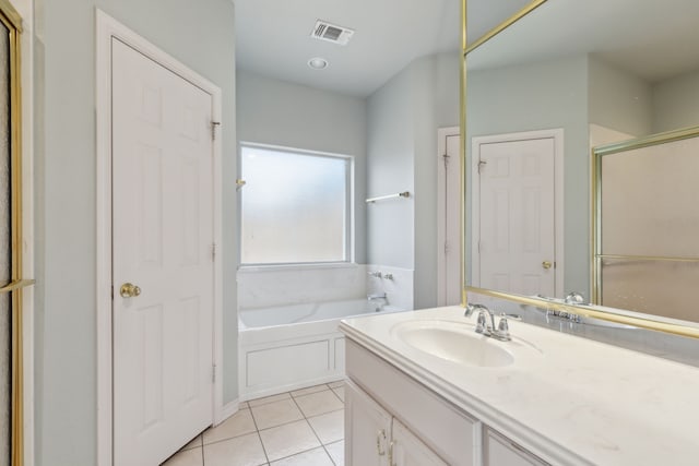 bathroom with tile patterned floors, visible vents, a bath, and vanity