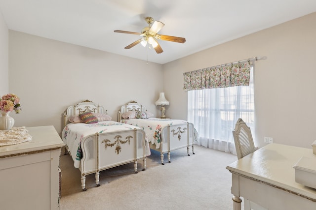 bedroom with a ceiling fan and light colored carpet