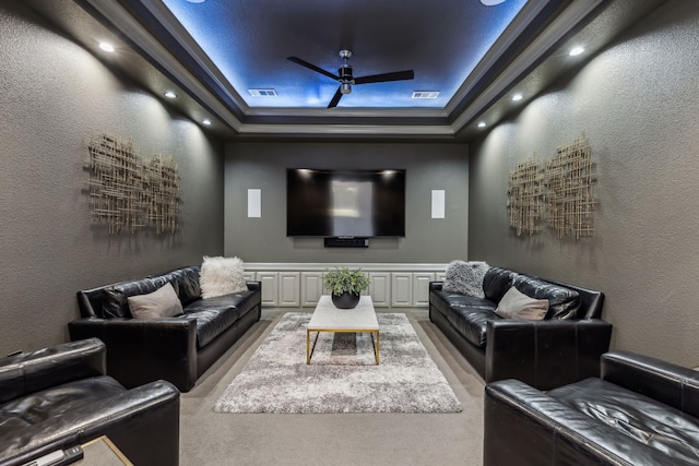 home theater featuring visible vents, a ceiling fan, and a textured wall