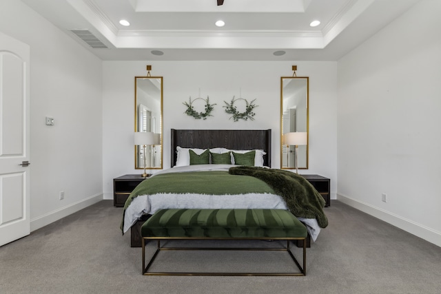 bedroom featuring a tray ceiling, carpet floors, visible vents, and ornamental molding