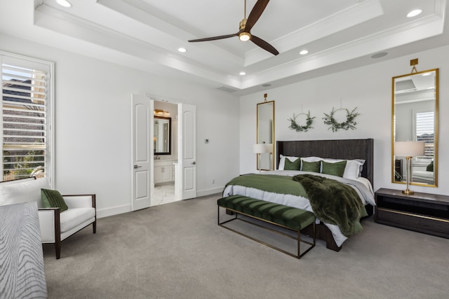 carpeted bedroom featuring a tray ceiling, recessed lighting, and crown molding