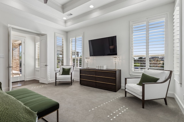 sitting room featuring visible vents, baseboards, carpet floors, crown molding, and a raised ceiling