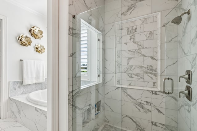 full bathroom featuring a garden tub, a marble finish shower, and ornamental molding