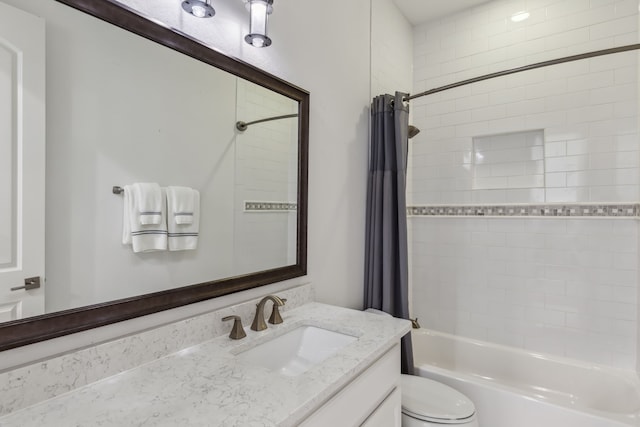 bathroom with vanity, toilet, and shower / tub combo