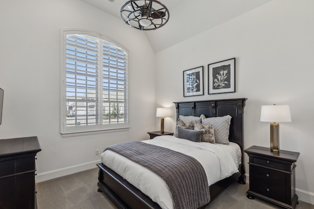 bedroom with baseboards, carpet floors, and lofted ceiling