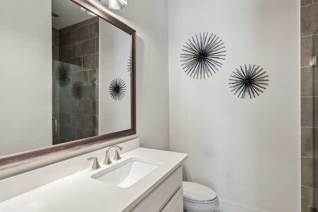 bathroom with vanity, toilet, and a stall shower