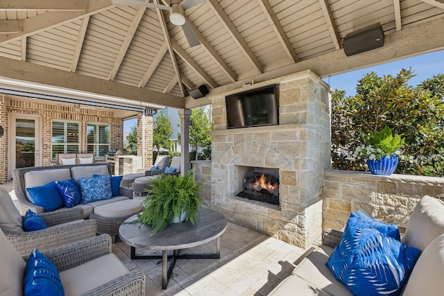 view of patio with an outdoor living space with a fireplace