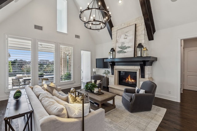 living area featuring visible vents, baseboards, a stone fireplace, and dark wood-style floors