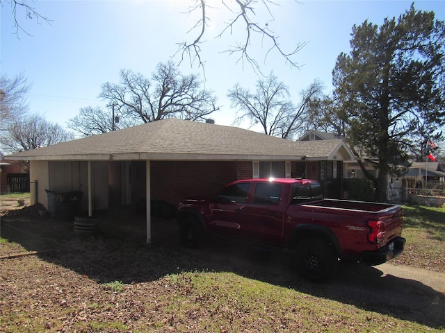 exterior space with brick siding and roof with shingles