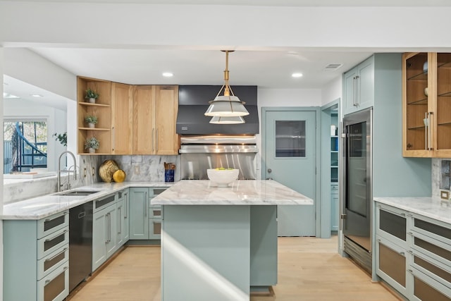 kitchen with light wood-style flooring, dishwasher, open shelves, and a sink