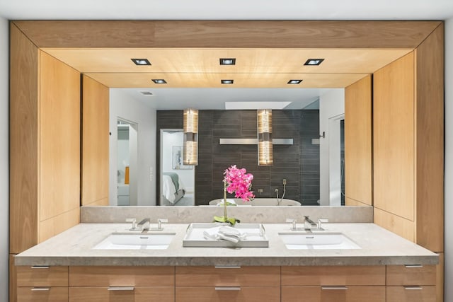 bathroom with a sink and double vanity