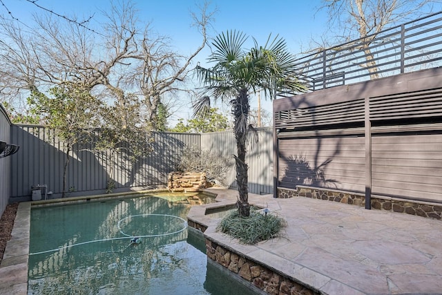 view of pool with an outdoor hot tub, a fenced in pool, a patio, and a fenced backyard