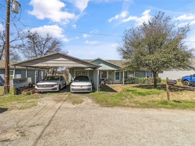 view of front of home featuring a detached carport and driveway