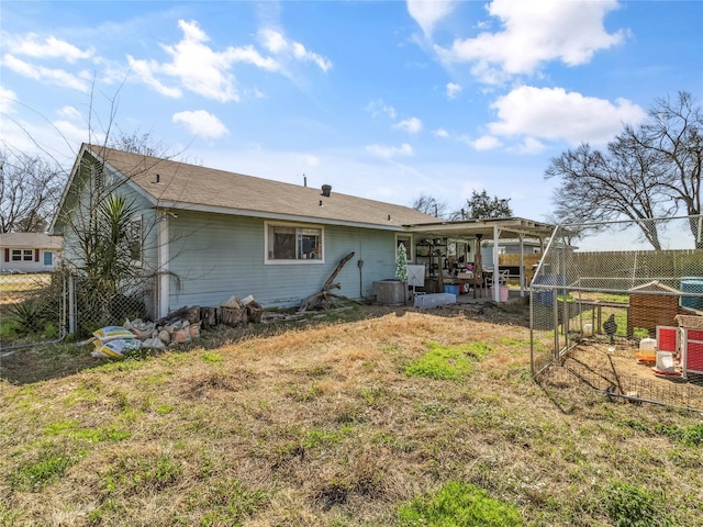 back of property featuring central AC unit and fence