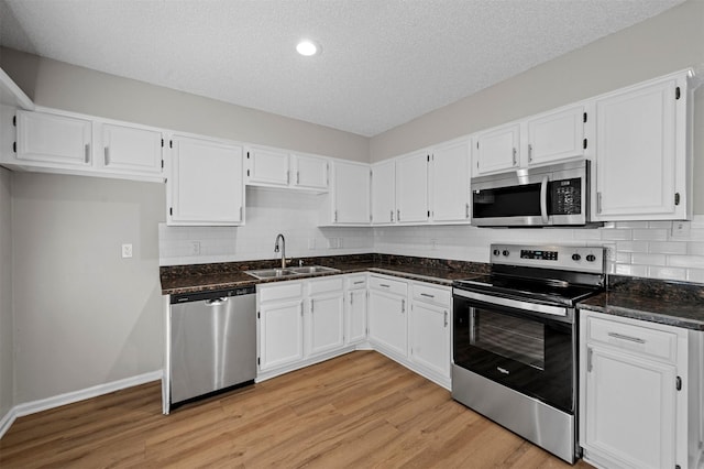 kitchen featuring a sink, white cabinets, and stainless steel appliances