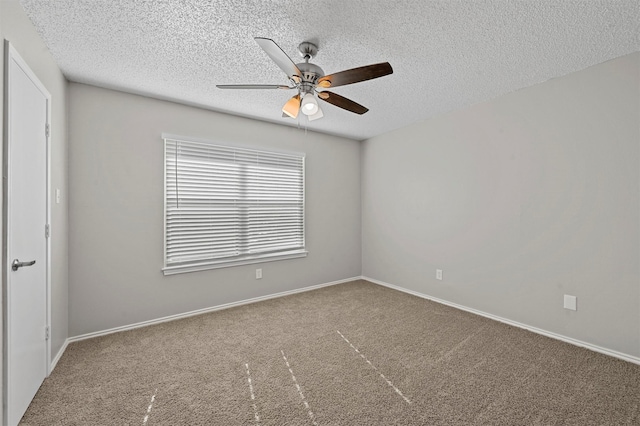 carpeted empty room featuring baseboards, a textured ceiling, and ceiling fan